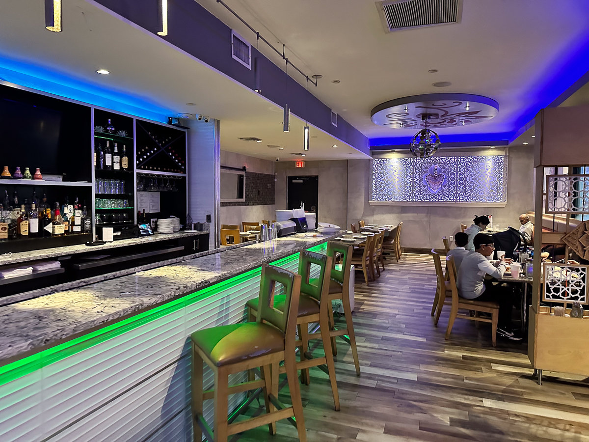 inside restaurant with bar and blue and green lights